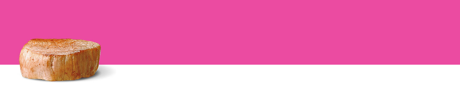 A cylindrical wooden object stands against a pink background.